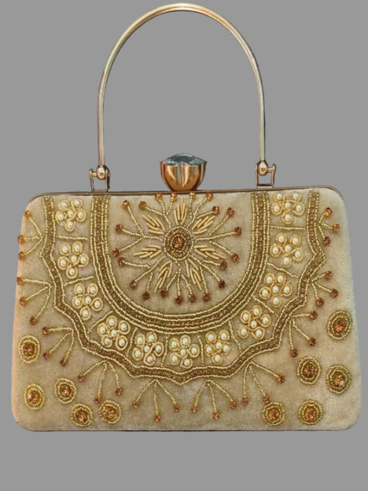 Decorative handbag with intricate gold embroidery on a gray background