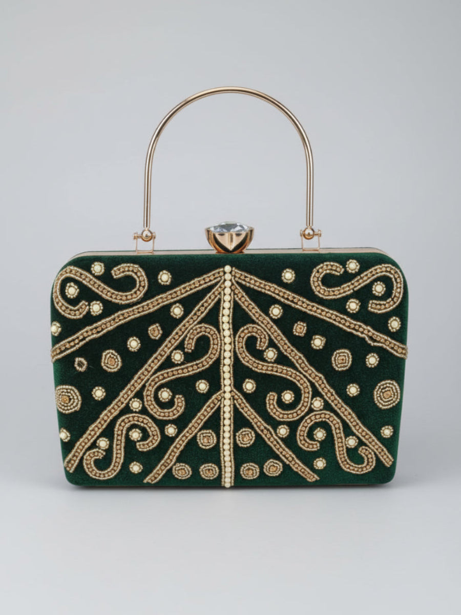 Green handbag with gold embroidery on a light gray background