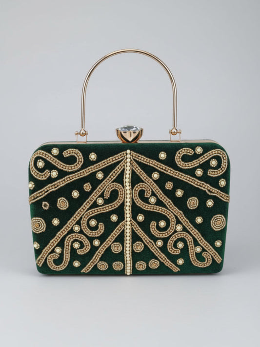 Green handbag with gold embroidery on a light gray background