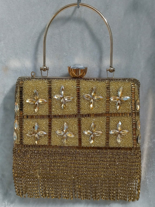 Gold beaded handbag with floral patterns on a gray background