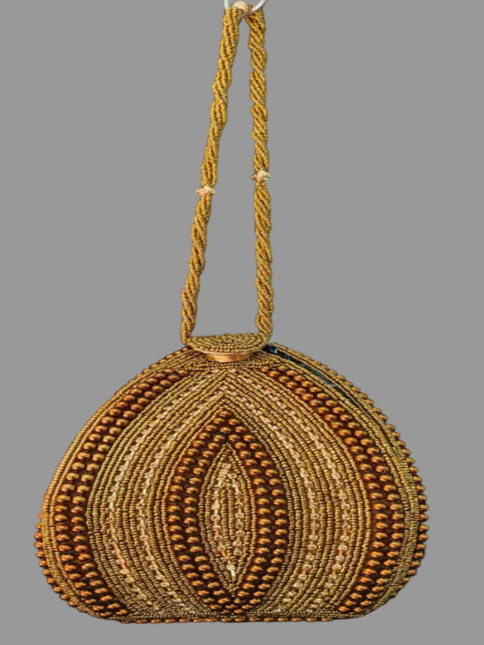 Gold beaded handbag with a strap on a gray background
