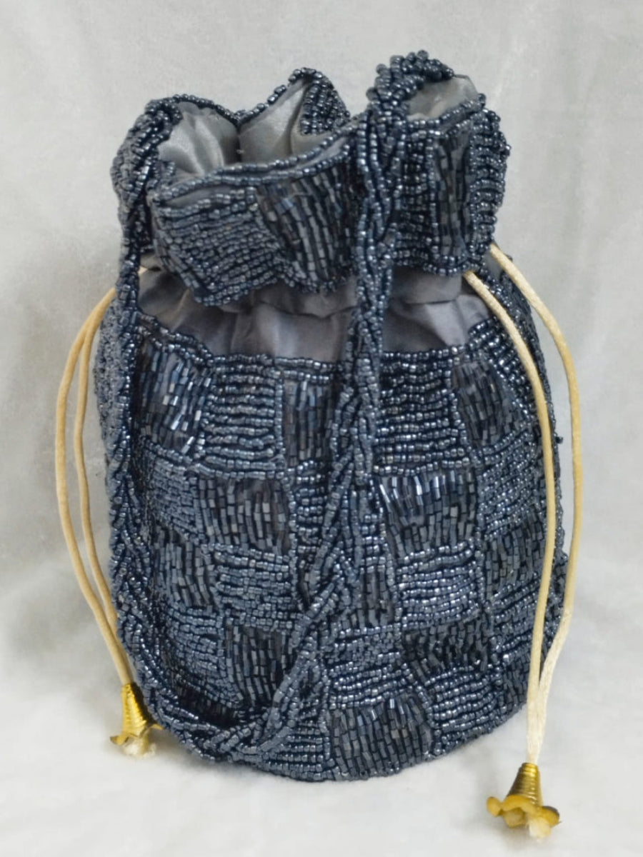Gray Beaded drawstring bag with gold accents on a light gray background