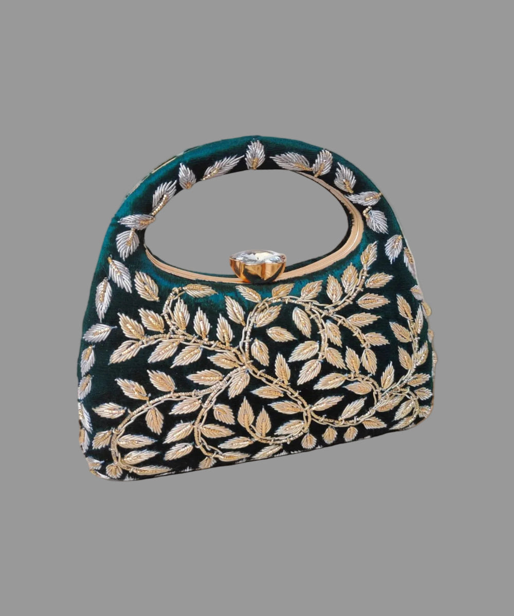 Decorative handbag with leaf patterns on a wooden surface with a soft background