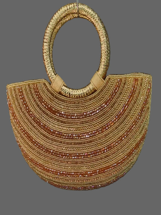 Woven handbag with circular handle on a gray background