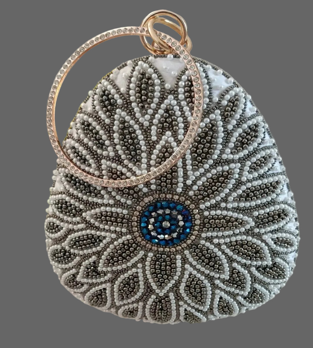Decorative handbag with beadwork and a blue center on a gray background