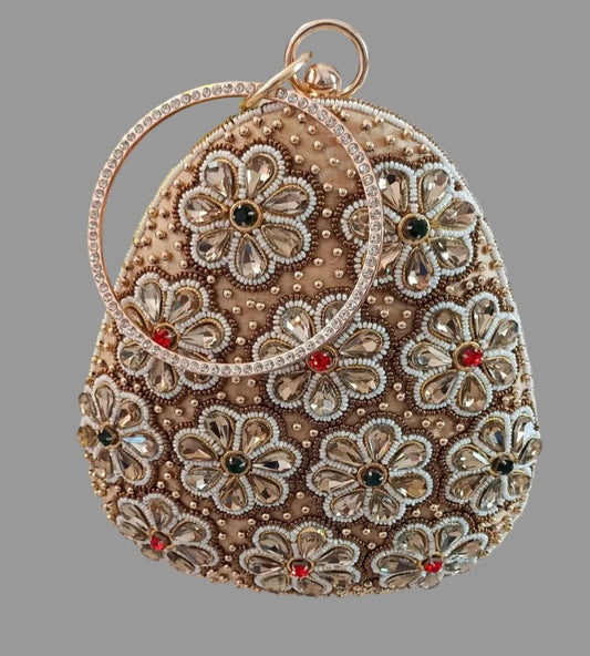 Decorative handbag with floral patterns and gemstones on a light background