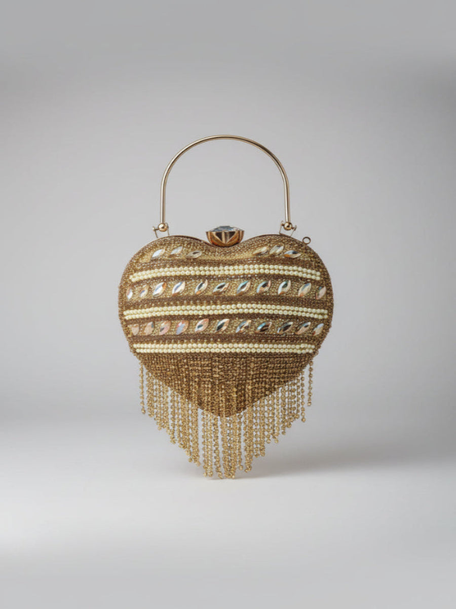 Gold beaded heart-shaped handbag on a light gray background