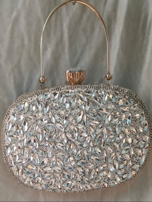 Elegant handbag with crystal embellishments on a neutral background