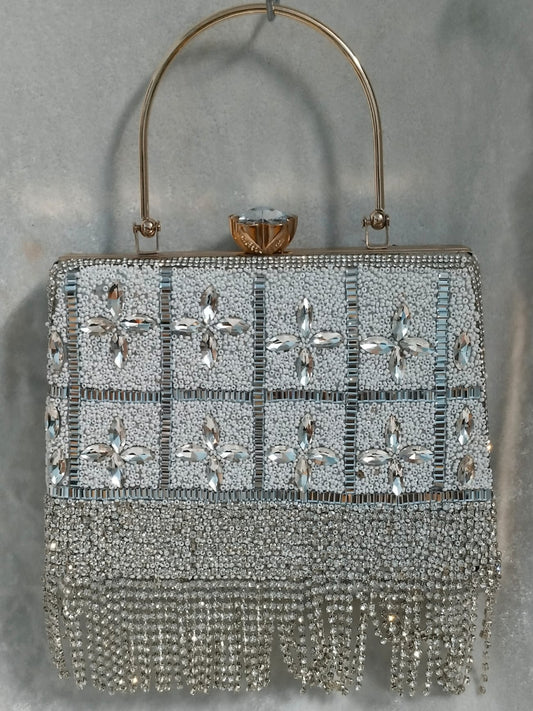 Elegant handbag with crystal embellishments on a gray background