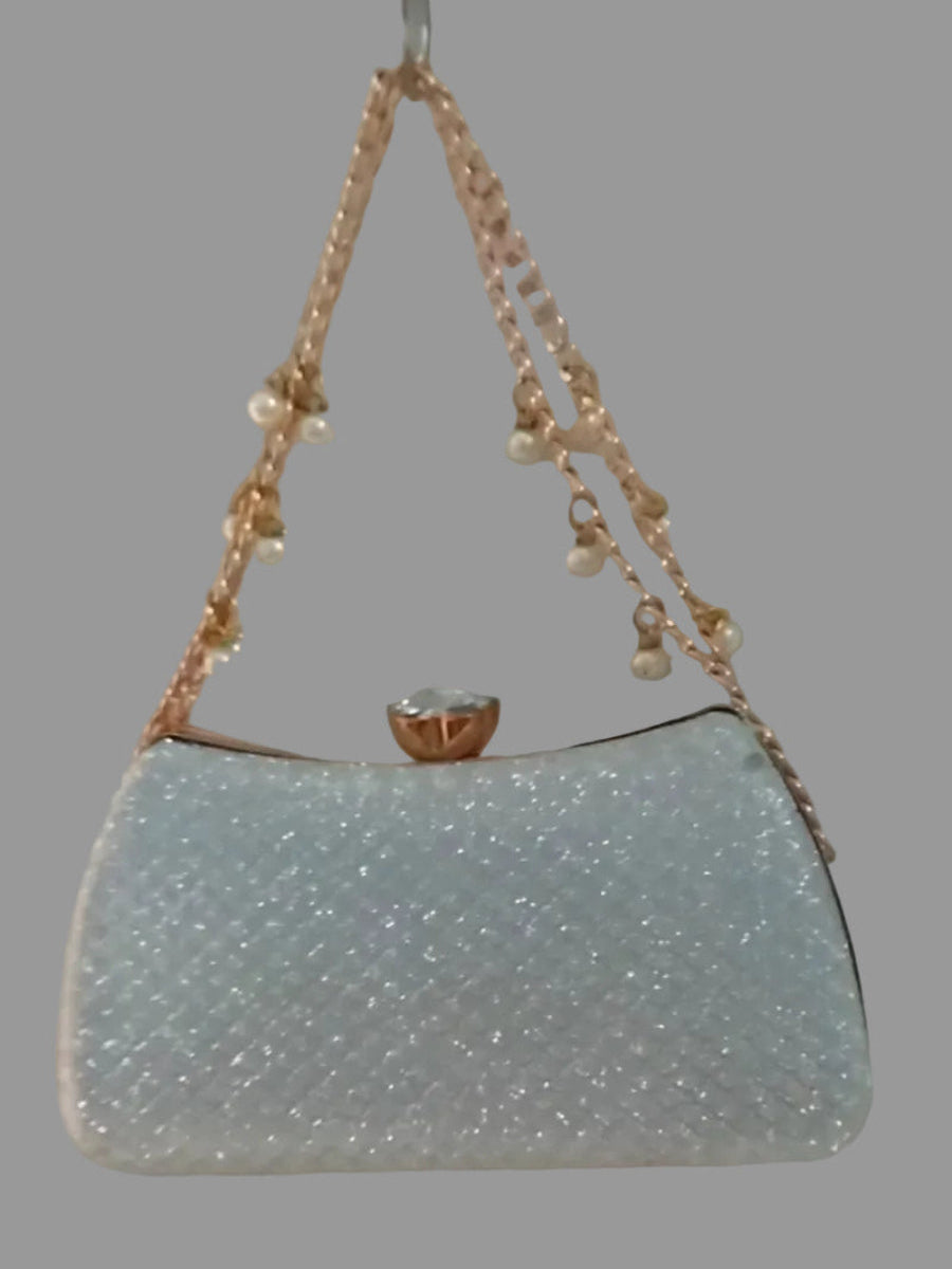 Light blue handbag with pearl handle on a gray background
