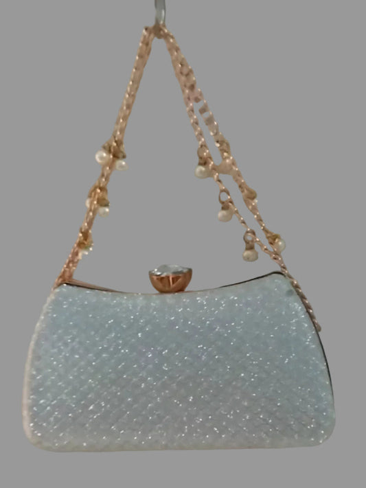 Light blue handbag with pearl handle on a gray background