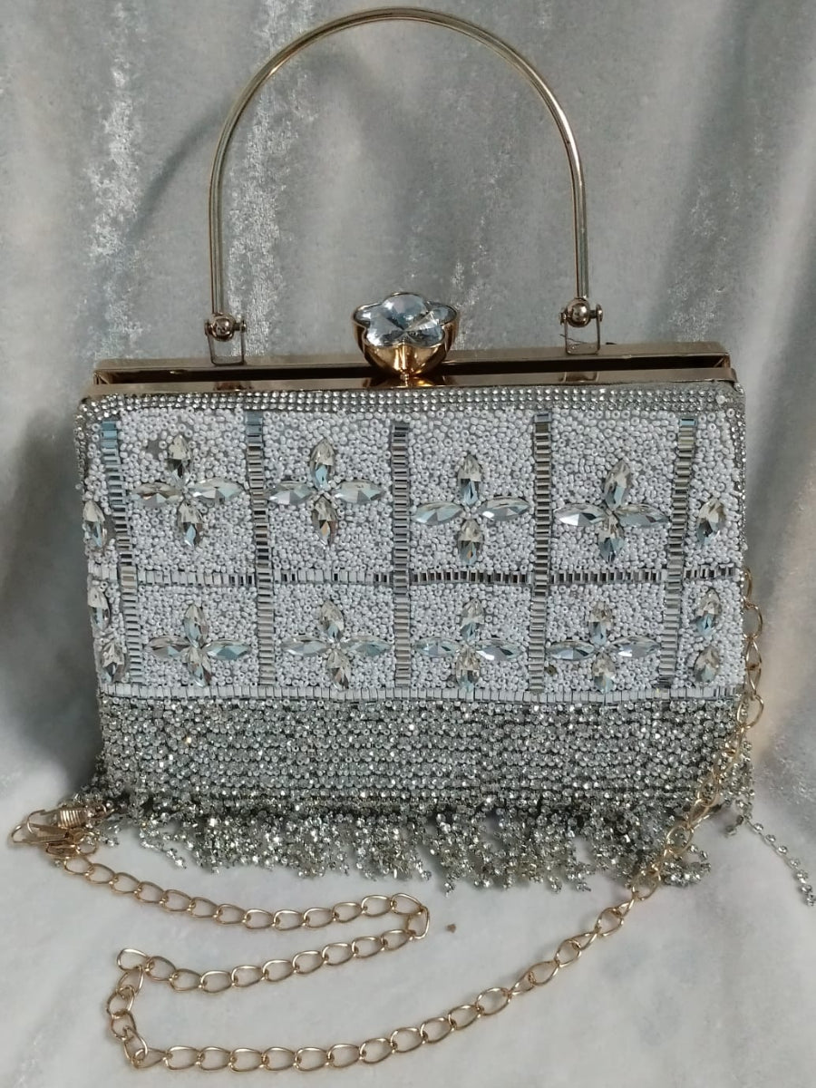 Silver beaded handbag with a chain strap on a light gray background