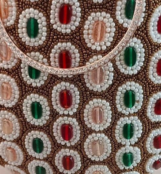 Beaded handbag with circular pattern on a light background