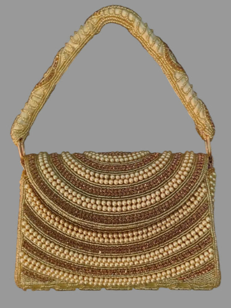 Handbag with decorative handle and multicolored pattern on a gray background