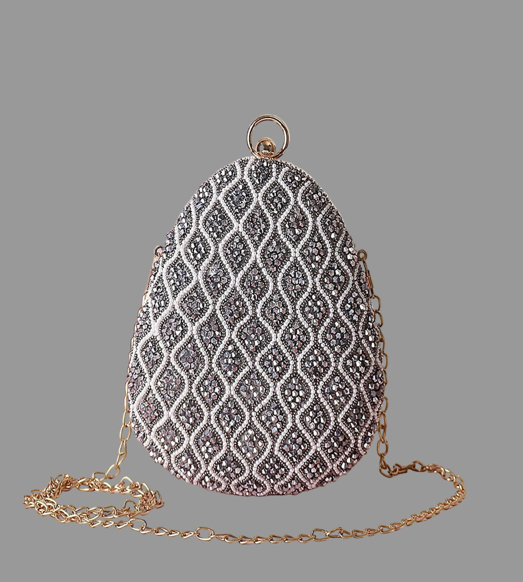 Decorative handbag with intricate pattern on a pink surface