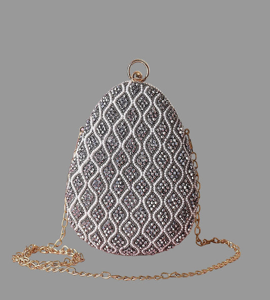 Decorative handbag with intricate pattern on a pink surface
