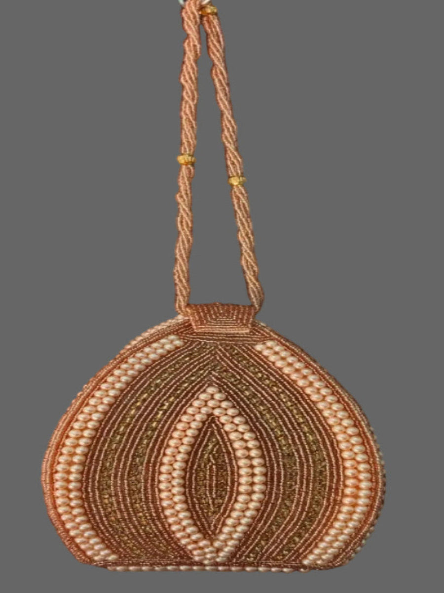Handmade beaded purse with intricate design on a gray background
