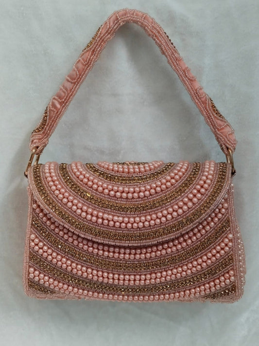Pink beaded handbag on a light gray background
