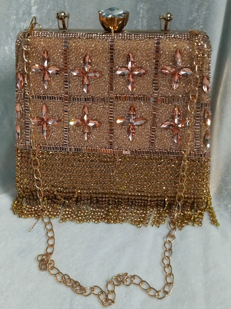 Gold beaded handbag with floral patterns on a light gray background