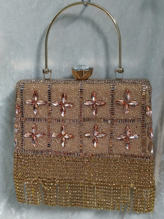 Gold beaded handbag with floral patterns on a gray background