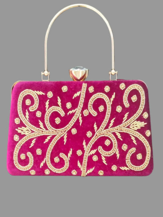 Pink handbag with gold embroidery on a gray background