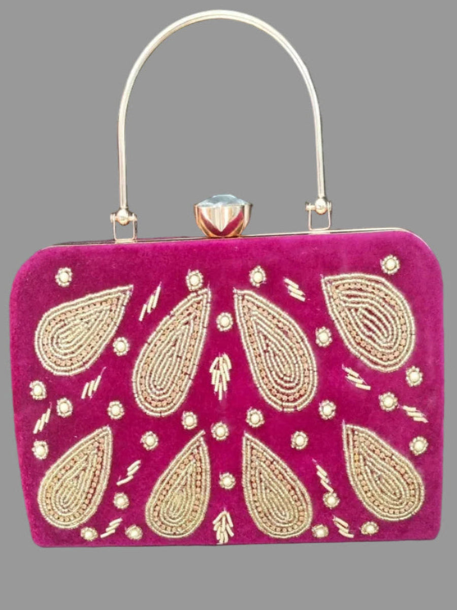 Pink handbag with gold embroidery on a gray background