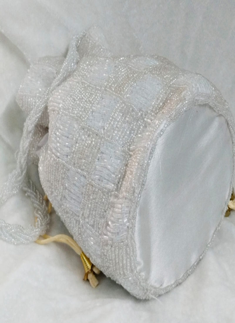 White beaded clutch bag on a light gray background