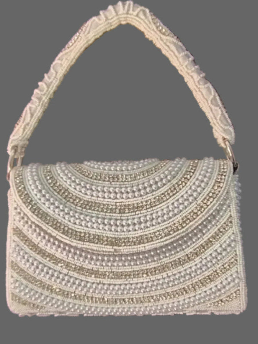 Elegant handbag with decorative handle on a gray background